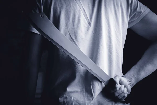 depositphotos_168247782-stock-photo-a-man-holds-a-machete